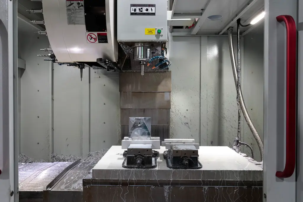 CNC milling machine cutting aluminum parts with coolant in a precision machining factory in China